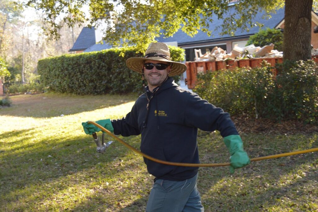 A Pro Care Lawn and Pest technician performing a spray treatment for pest control in Jacksonville, FL.