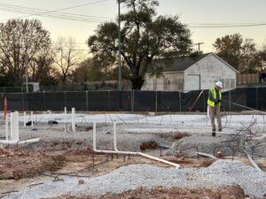 A pest control technician spraying the foundation of a new construction site for Reliable Pest Management in Springfield, MO.