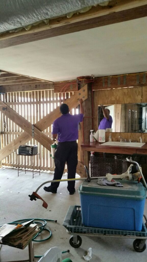 A pest control technician spraying inside a building to eliminate pests for General Pest Solutions in Summerville, SC.