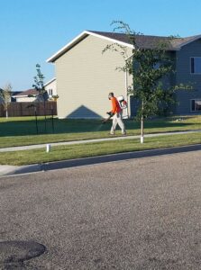 A Skeeter Defeeter pest control technician spraying a lawn for mosquitoes in Aberdeen, SD.