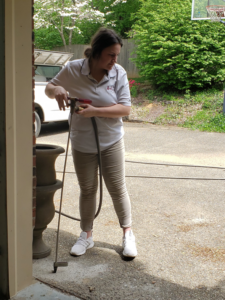 A pest control technician applying an exterior pest treatment with a spray wand for a client in Louisville, KY, by A-1 Pest Control, Inc.