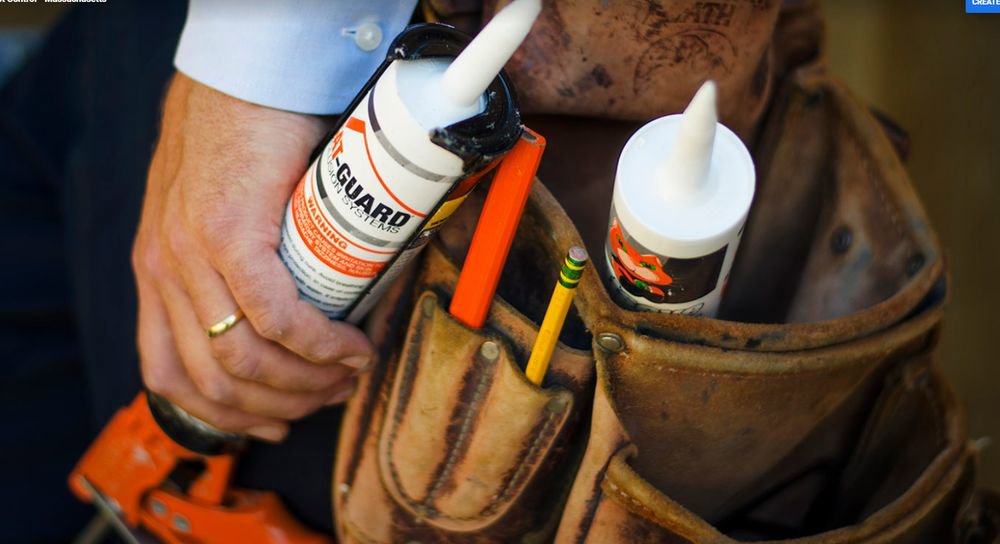 Close-up of a Catseye Pest Control technician's tool belt with Cat-Guard exclusion sealant in Hartford, CT.