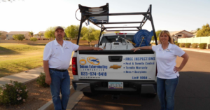 Two pest control technicians with their branded service truck and equipment from Dobson Exterminating Company LLC in Peoria, AZ