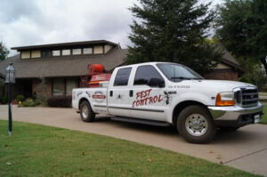 A Reliable Termite of OKC pest control truck parked in front of a residential home in Oklahoma City, OK.