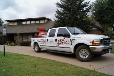 A Reliable Termite of OKC pest control truck parked in front of a residential home in Oklahoma City, OK.