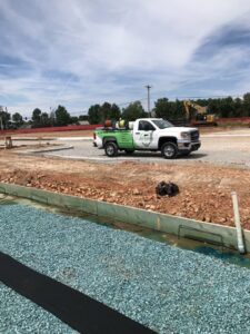 An Action Pest And Turf service truck at a construction site for pest control in Springdale, AR.