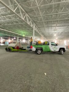 An Action Pest And Turf truck with pest control equipment at a construction site in Springdale, AR.
