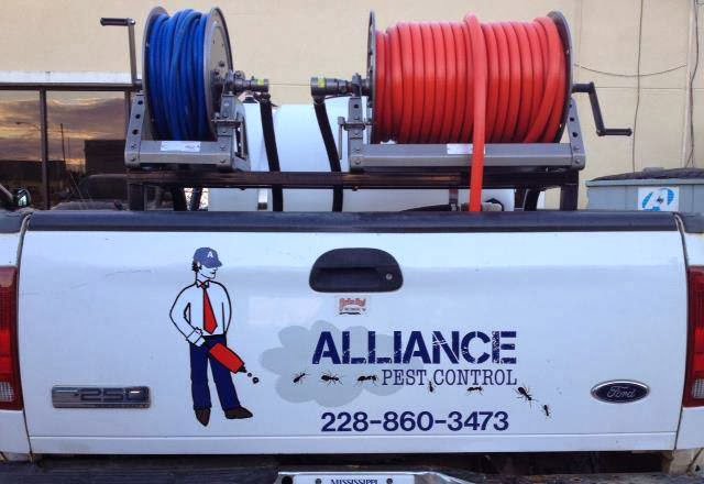 A white pickup truck with pest control equipment and Alliance Pest Control branding in Alliance, OH