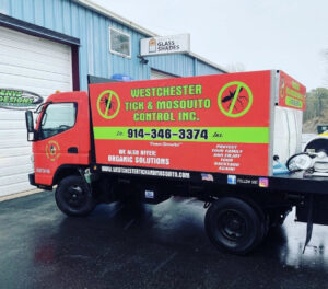 A Westchester Tick and Mosquito Control truck with pest control equipment parked in New Rochelle, NY.
