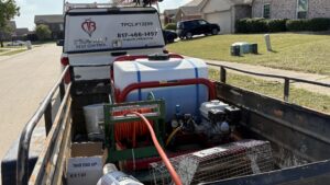The back of a D' Bug Man Pest Control truck loaded with pest control equipment and a wildlife trap in Arlington, TX.