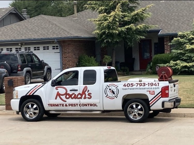 A Roach's Termite Service Inc. truck with pest control equipment parked at a residential job site in Oklahoma City, OK