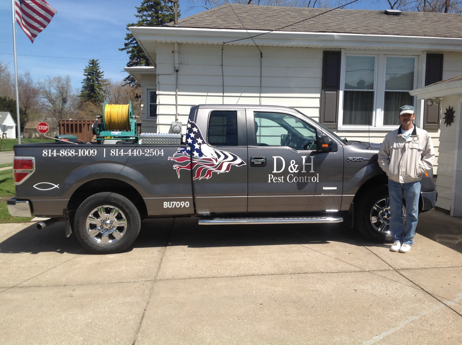 A D & H Pest Control truck with spraying equipment parked at a residential property for a pest control job in Erie, PA.