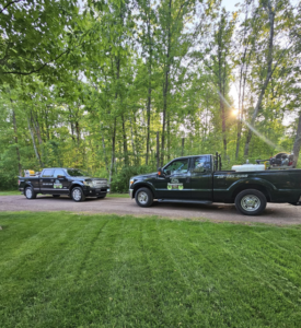 Two pest control trucks with spray equipment ready for a job at BugMeisters North in Lindstrom, MN