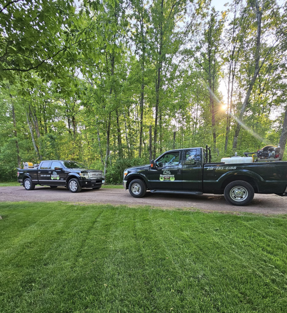 Two pest control trucks with spray equipment ready for a job at BugMeisters North in Lindstrom, MN