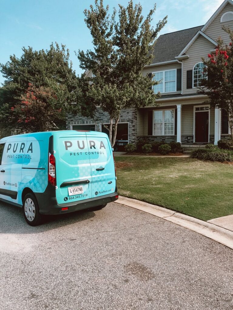 Pura Pest Control van parked at a suburban home for service in Greenville, SC