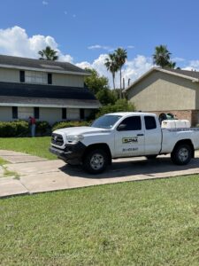 A Solutions Pest Management worker spraying a residential property for pest control in Corpus Christi, TX.