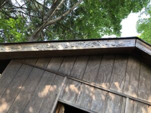 Damaged wood on the eaves and roofline, showing signs of pest activity requiring services from Pest by MD in Jersey City, NJ.