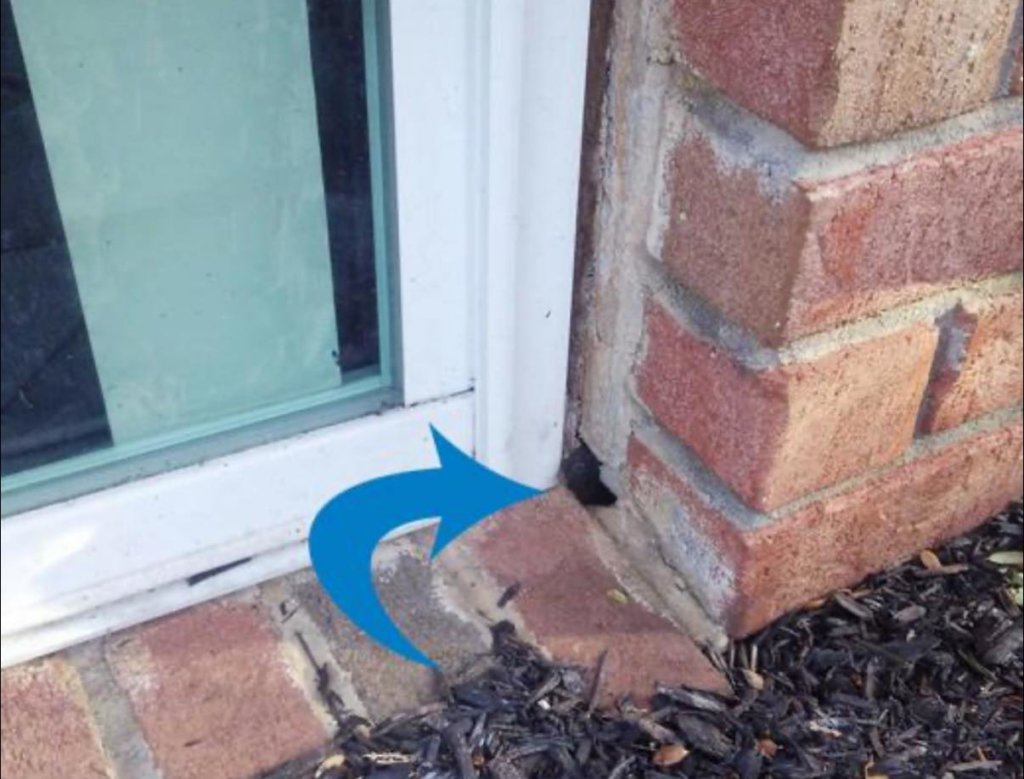 A potential pest entry point in a brick wall next to a window, identified by Pest Badger in Chippewa Falls, WI.
