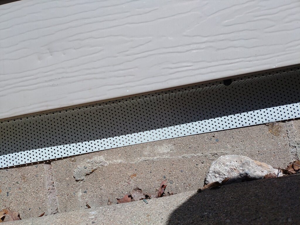 A perforated metal barrier installed along a house foundation for effective pest exclusion by Enviro-Pest Solutions in Waterloo, IA.