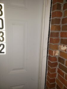 Close-up of a door frame and brick wall showing pest exclusion sealing by Absolute Exterminating Services in Ellenwood, GA.