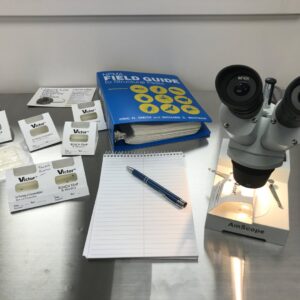 A pest identification station with a microscope, field guide, and traps at Perimetek Pest Management in East Syracuse, NY.