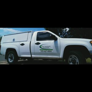 A white Pest Solutions Exterminating service truck with company branding on the side in Broken Arrow, OK.