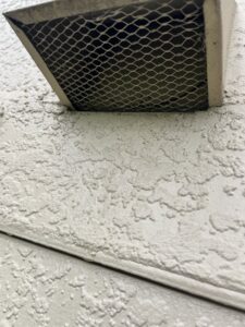 A close-up of a screened vent, demonstrating pest and wildlife exclusion services by Sorko Services in Sanford, FL.