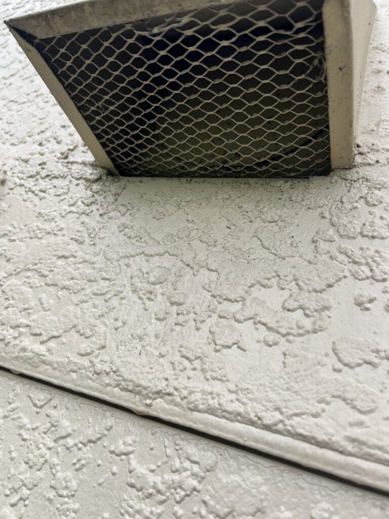 A close-up of a screened vent, demonstrating pest and wildlife exclusion services by Sorko Services in Sanford, FL.