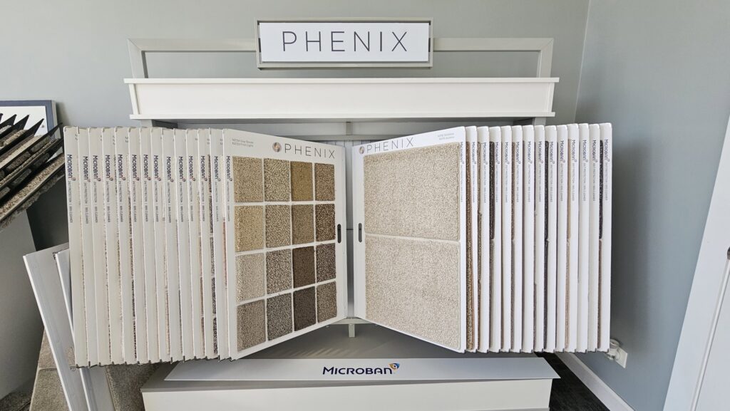 A showroom display featuring various Phenix carpet samples for selection at Carpets Direct Naperville, IL.