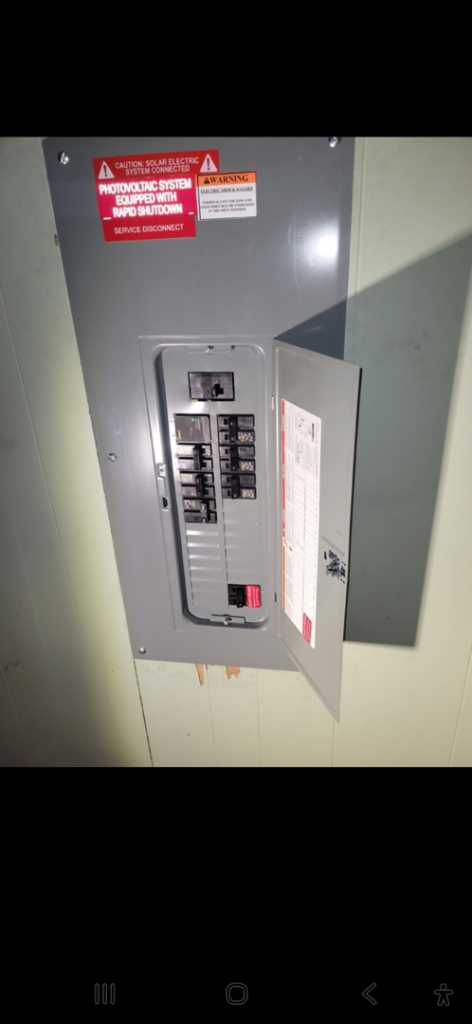An electrical panel for a photovoltaic system with a service disconnect, installed by ANT POWER LLC in Tacoma, WA.