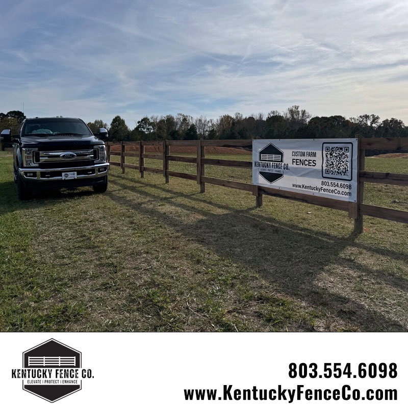 A black pickup truck parked next to a newly installed wooden fence by Kentucky Fence Co in McConnells, SC.