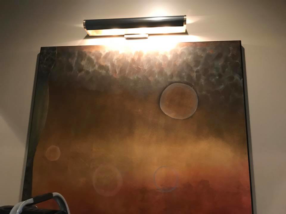 A modern picture light installed above artwork by Cothern Electric, LLC in Jonesboro, AR.