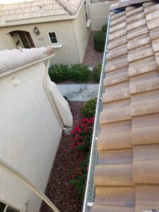 A mesh barrier installed along a narrow side yard roofline for effective pigeon control by Pigeon Problem Solvers, LLC in Scottsdale, AZ.