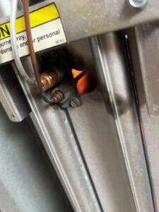 A close-up view of a pilot light or burner inside a heating system inspected by David J. Winston Co. in Erie, PA.