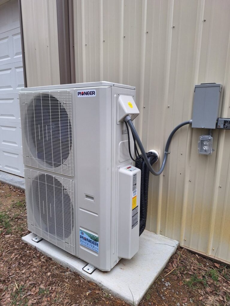A Pioneer mini-split condenser unit installed outside a building by Recovery HVAC in Smyrna, TN.