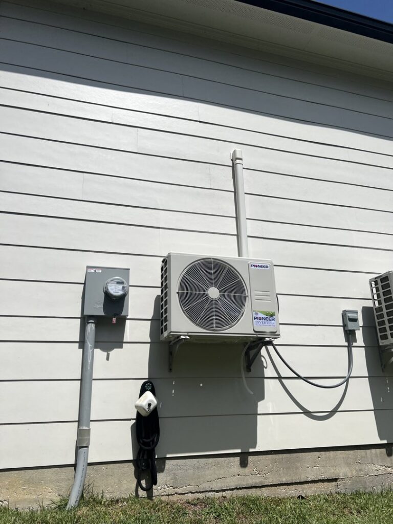 A Pioneer mini-split outdoor unit installed on the side of a house by Comfort Zone AC and Heating Services LLC in Sunrise Beach, MO