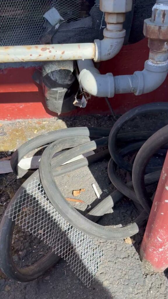 Metal mesh installed around pipes and wires to prevent pest entry by Rogue Valley Extermination & Pest Control in Medford, OR.