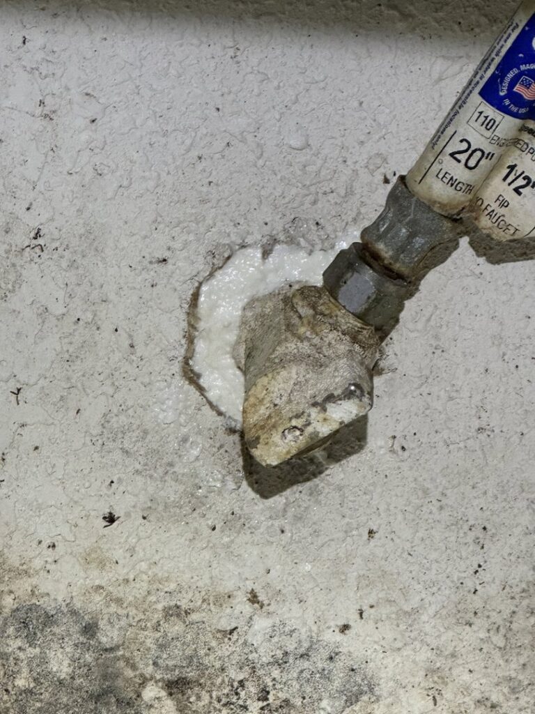 A pipe sealed with foam in a wall, demonstrating pest exclusion work by Pike Creek Exterminating in Kenosha, WI.