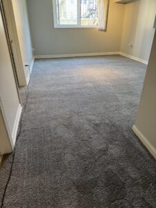 A room with a fresh plain grey carpet installation by New City Carpet And Flooring in Chicago, IL