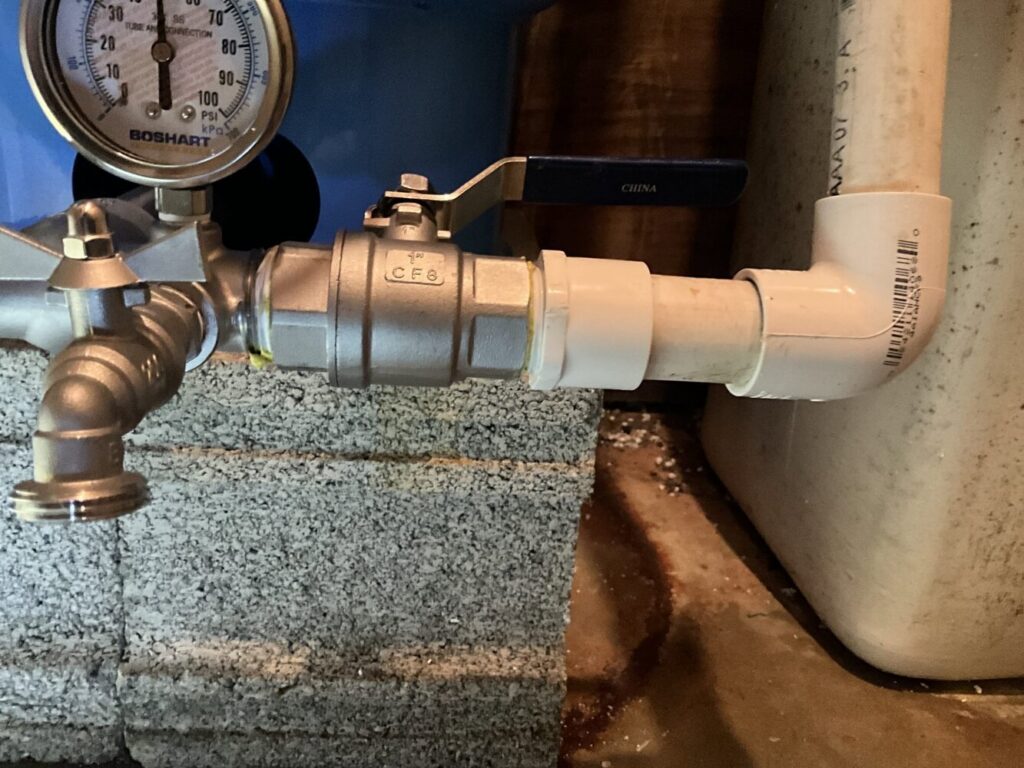 Close-up of plumbing pipes, a valve, and a pressure gauge, indicating service by Markool Heating Cooling Plumbing in Frederick, MD.