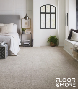 A cozy bedroom with a soft, plush carpet installed by Floor & More in San Marcos, CA.