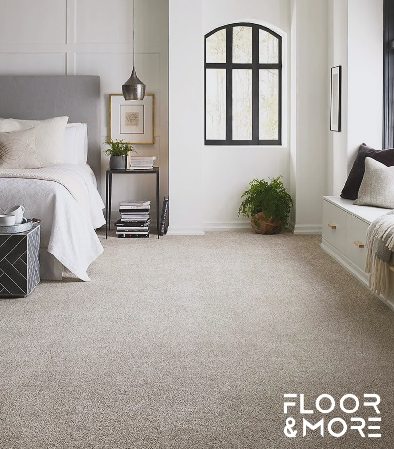 A cozy bedroom with a soft, plush carpet installed by Floor & More in San Marcos, CA.