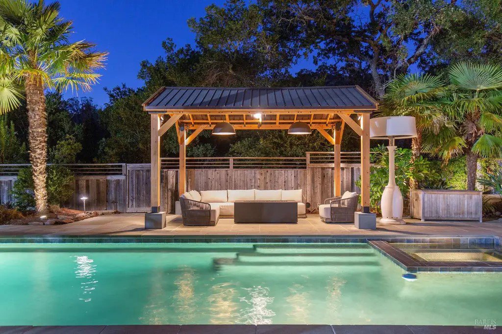 Outdoor pool area with illuminated pergola and landscape lighting installed by R.C Electric, Inc. in San Francisco, CA