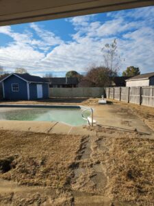 A sturdy wood privacy fence enclosing a pool area, expertly installed by The Fence Dudes in Birmingham, AL.