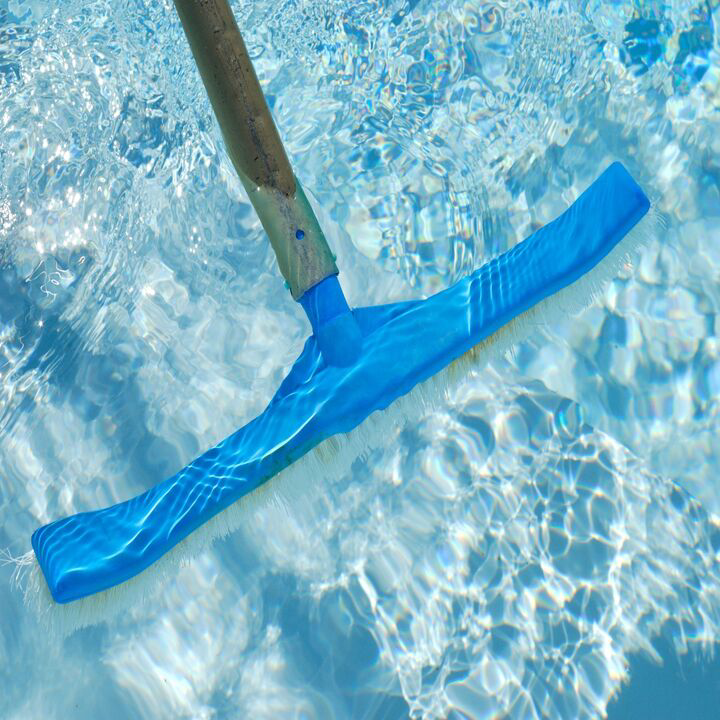 A blue pool brush on a pole cleaning the clear water, demonstrating services by Bryan Simpson in Services Available In.