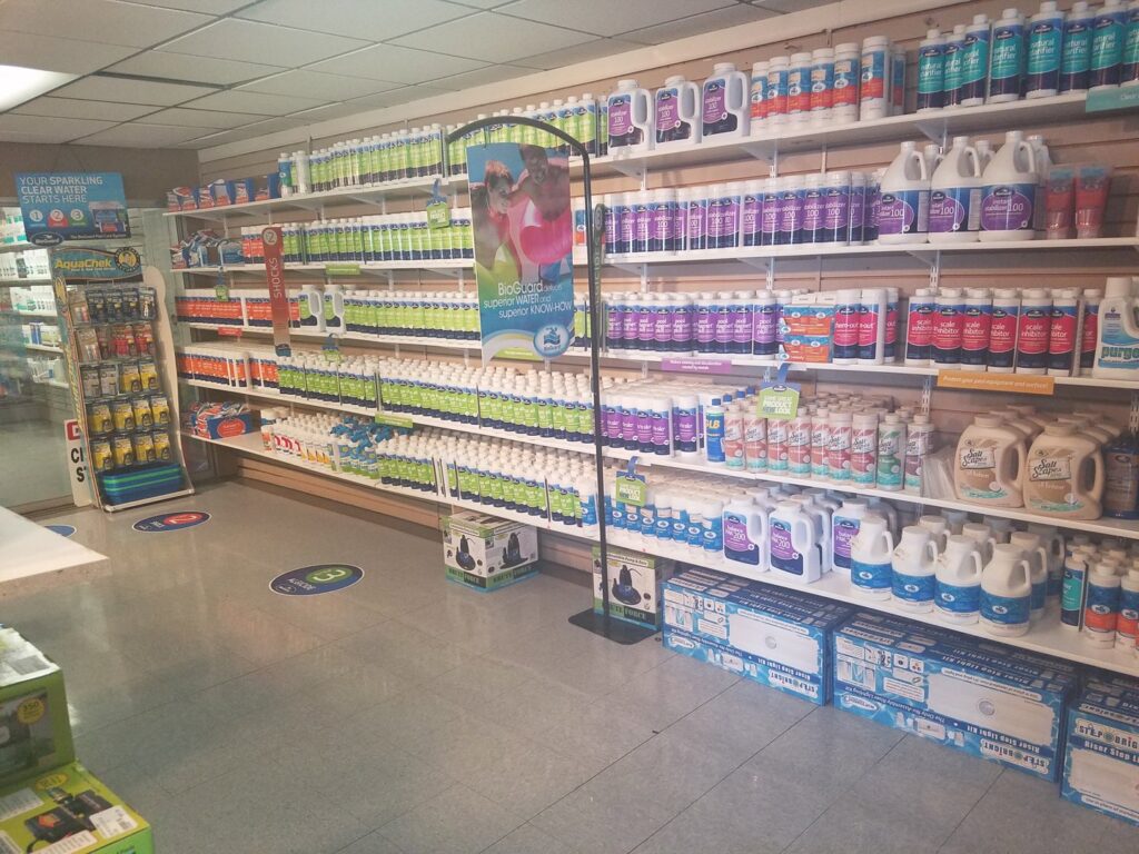 An aisle stocked with various pool chemicals and supplies at Firemaster in Oklahoma City, OK