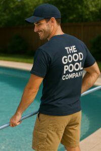 A pool cleaner from The Good Pool Company skimming the pool with a long pole in Scottsdale, AZ.
