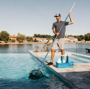 A pool cleaner skimming leaves and debris from a residential pool at The Pool Service Pros in New Hill, NC.
