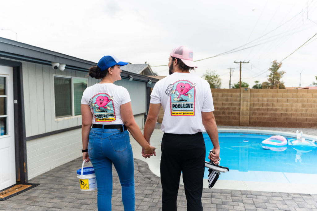 Two AZ Pool Love team members with cleaning tools ready to service a pool in Mesa, AZ