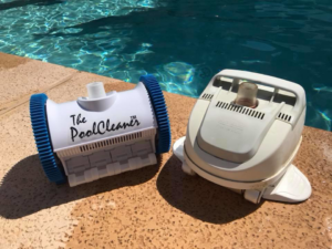 Two pool cleaning robots on the edge of a sparkling pool by Classic Pool Service in Surprise, AZ